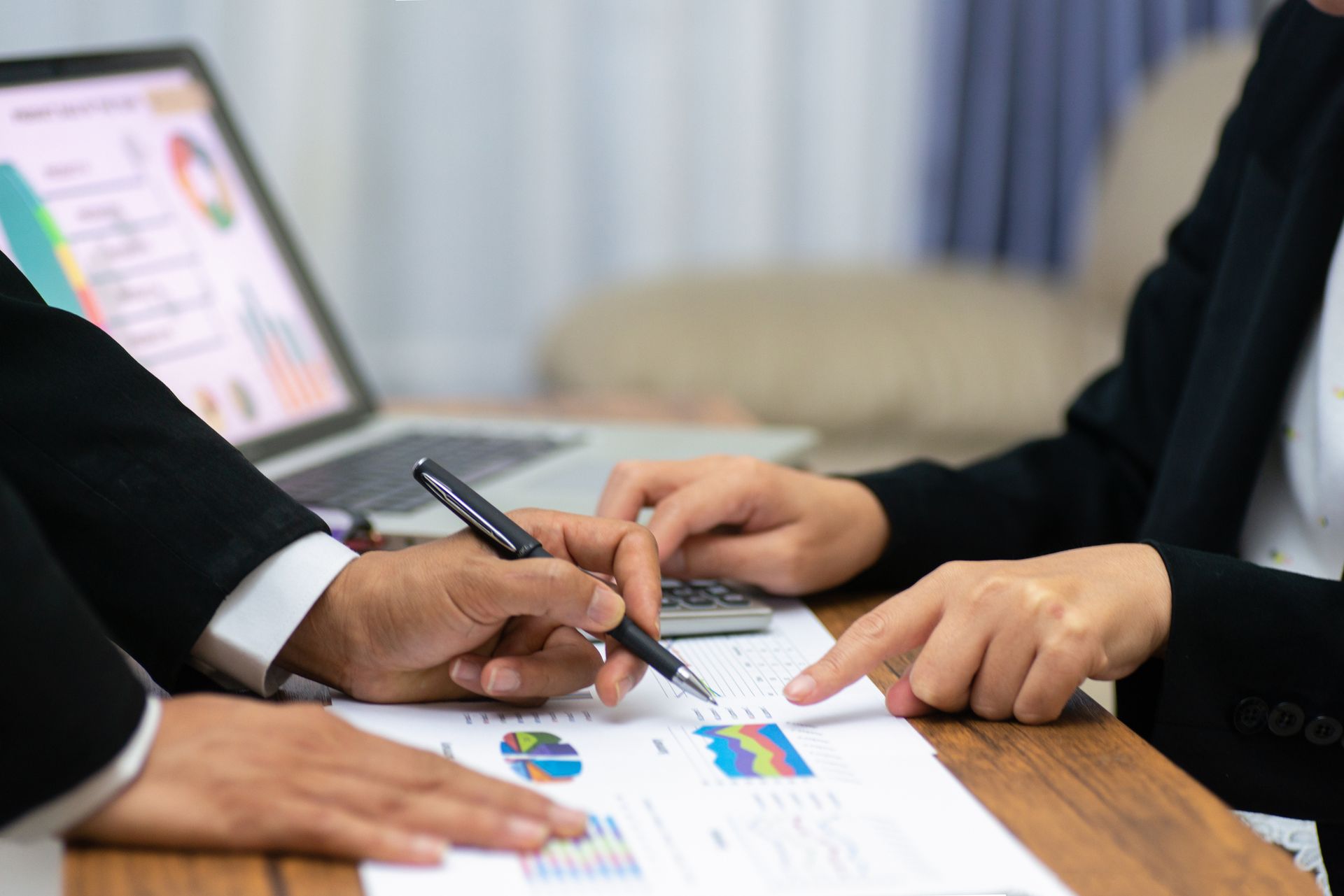 A man and a woman are sitting at a table looking at a piece of paper.