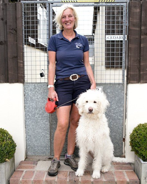 woman stood with large white dog