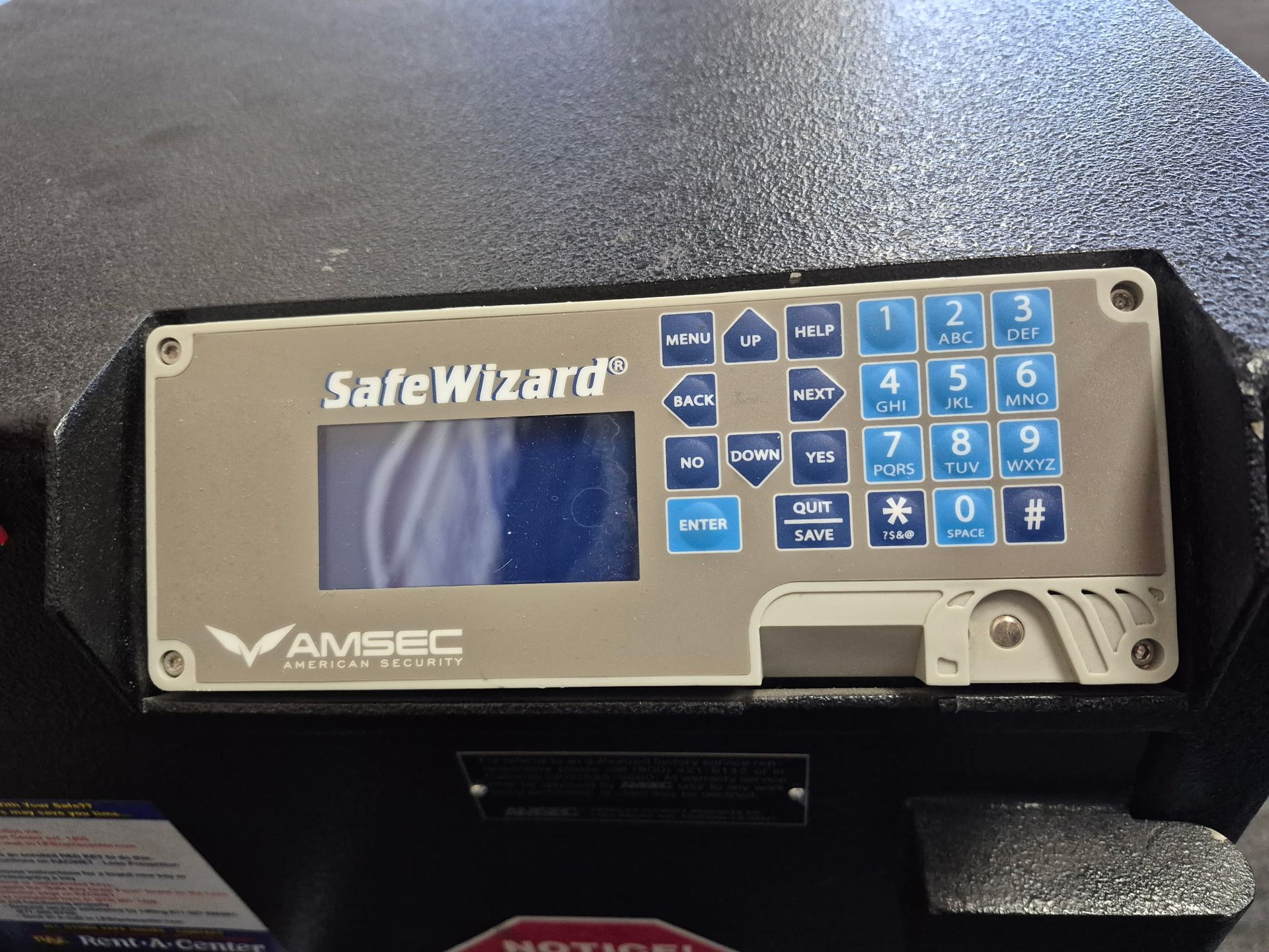 SafeWizard control panel with blue keypad and screen on a black case on a countertop