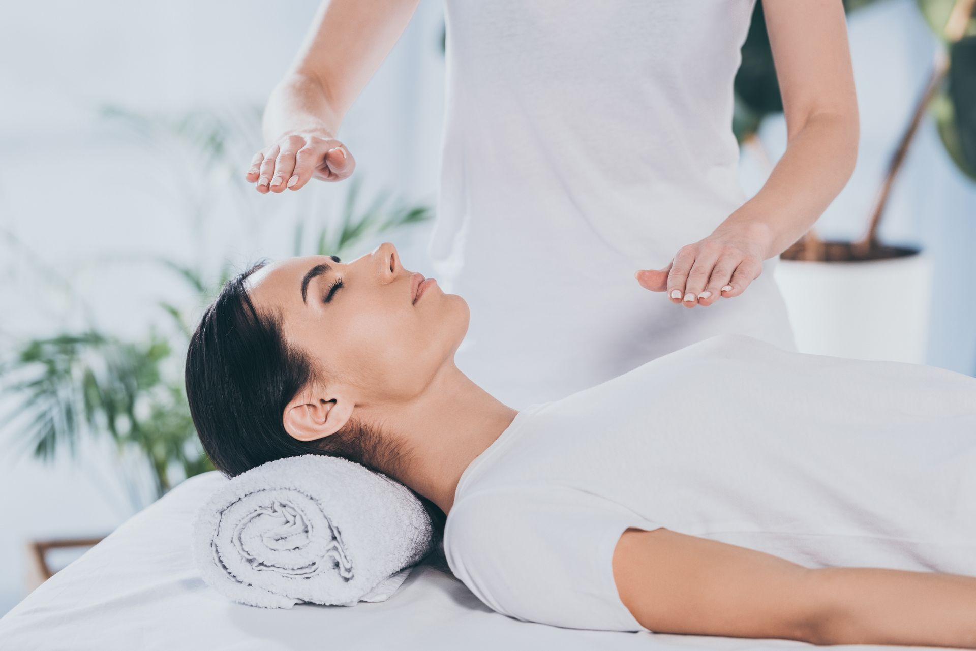 Hands massaging a person’s back during a spa treatment
