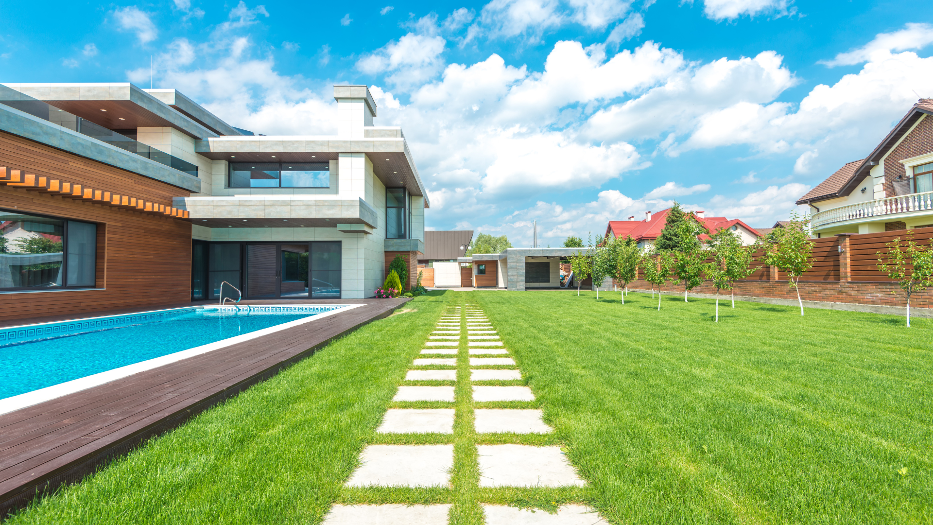 a lawn with purple flowers and a white curb .