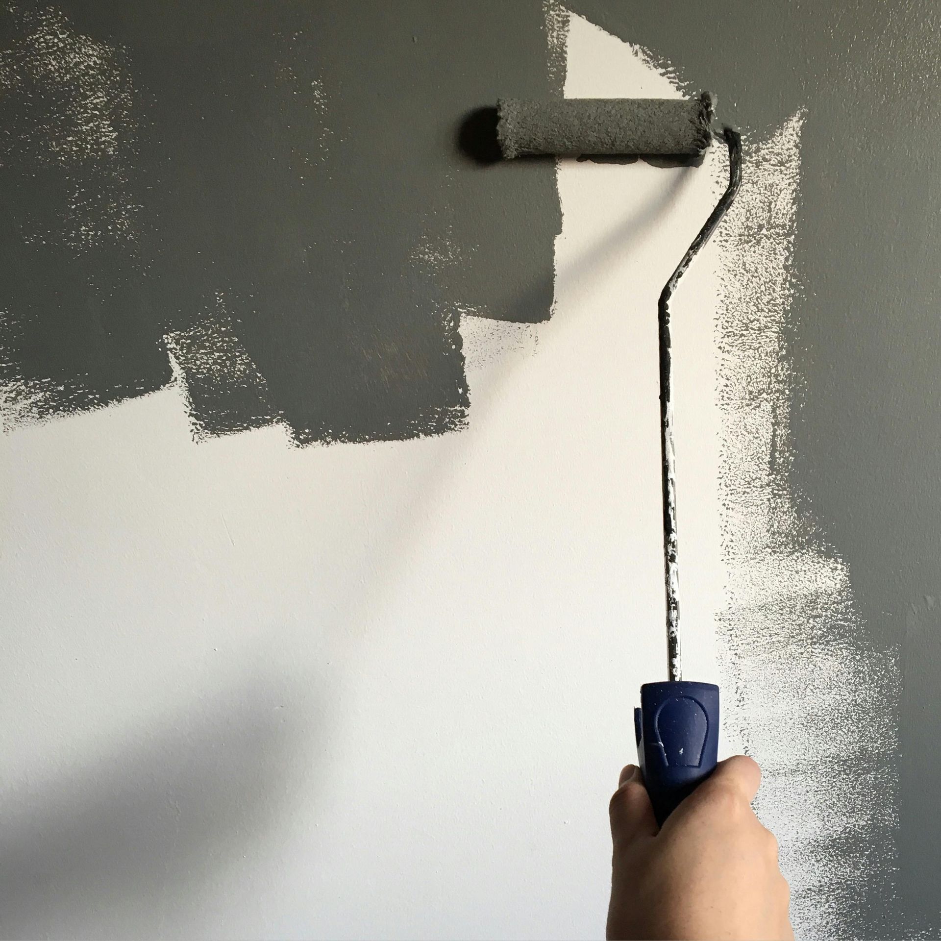 an empty room with a wooden floor and a ladder .