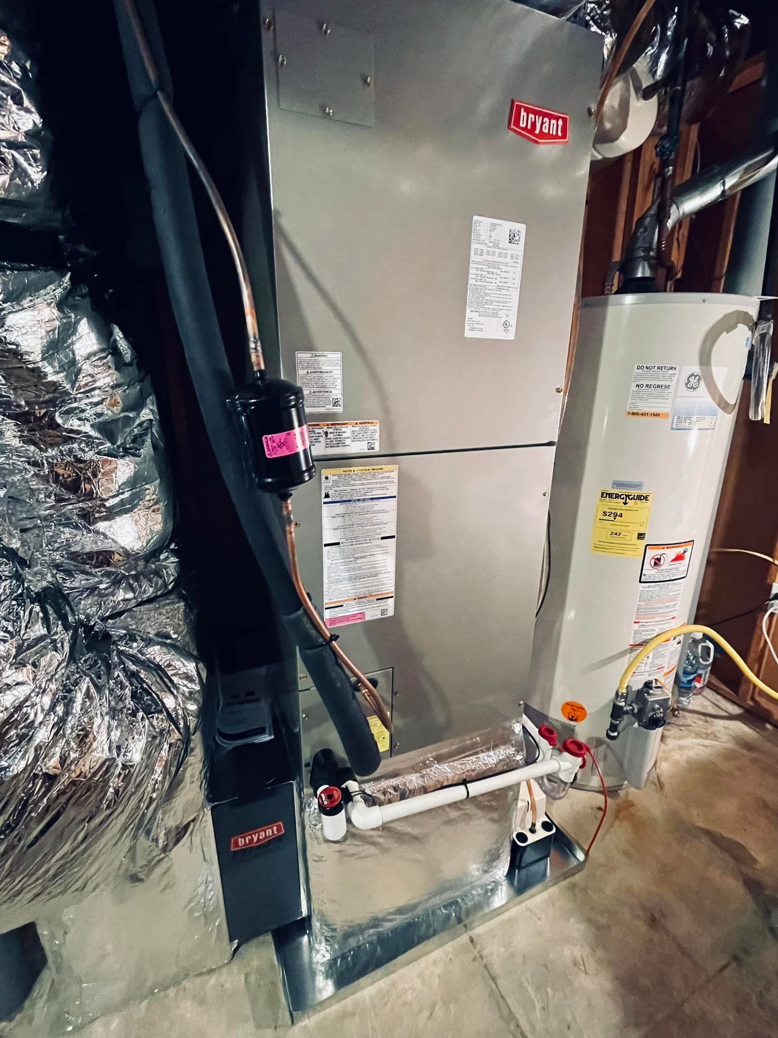 A heating and cooling system in a basement with a water heater.