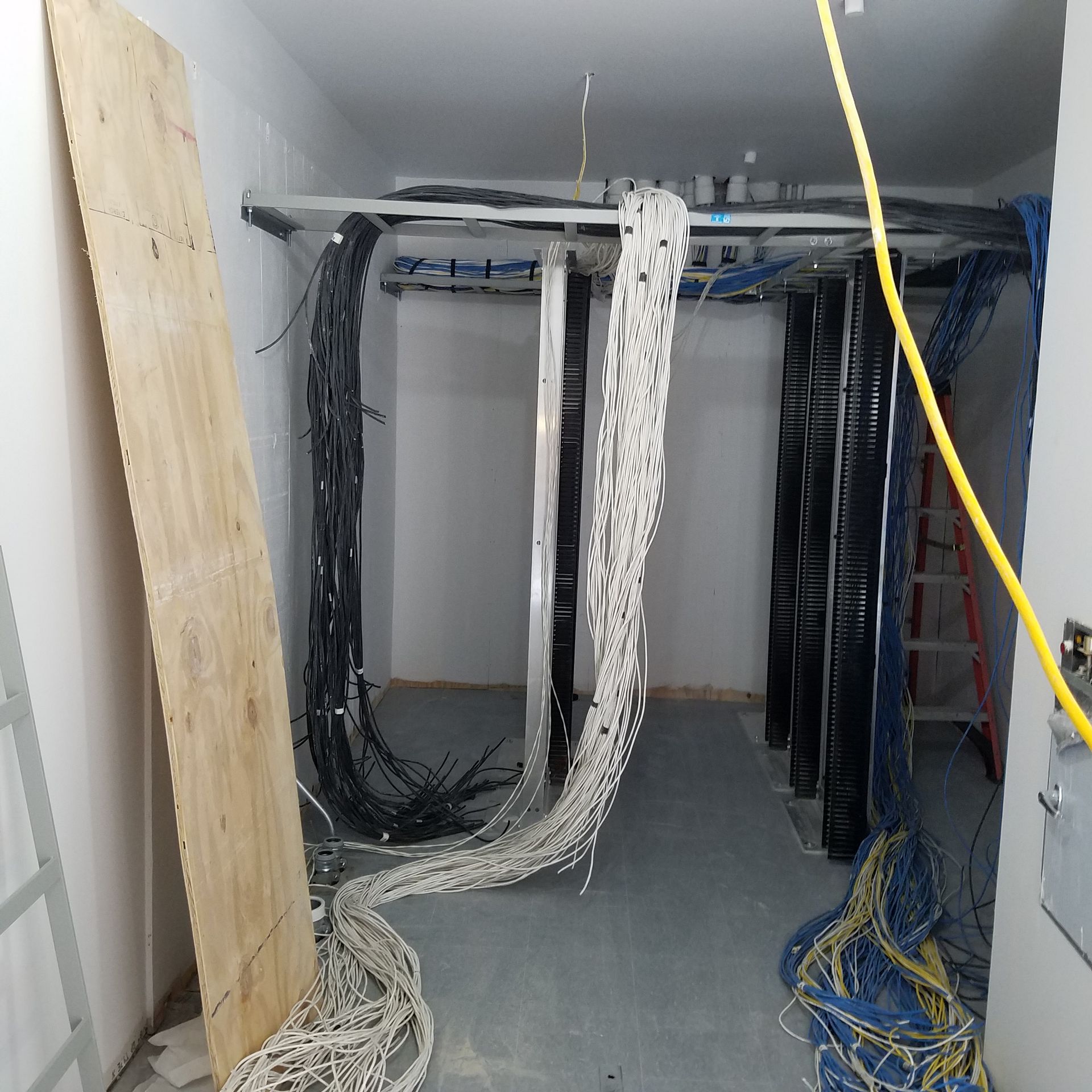 A room with a lot of wires hanging from the ceiling