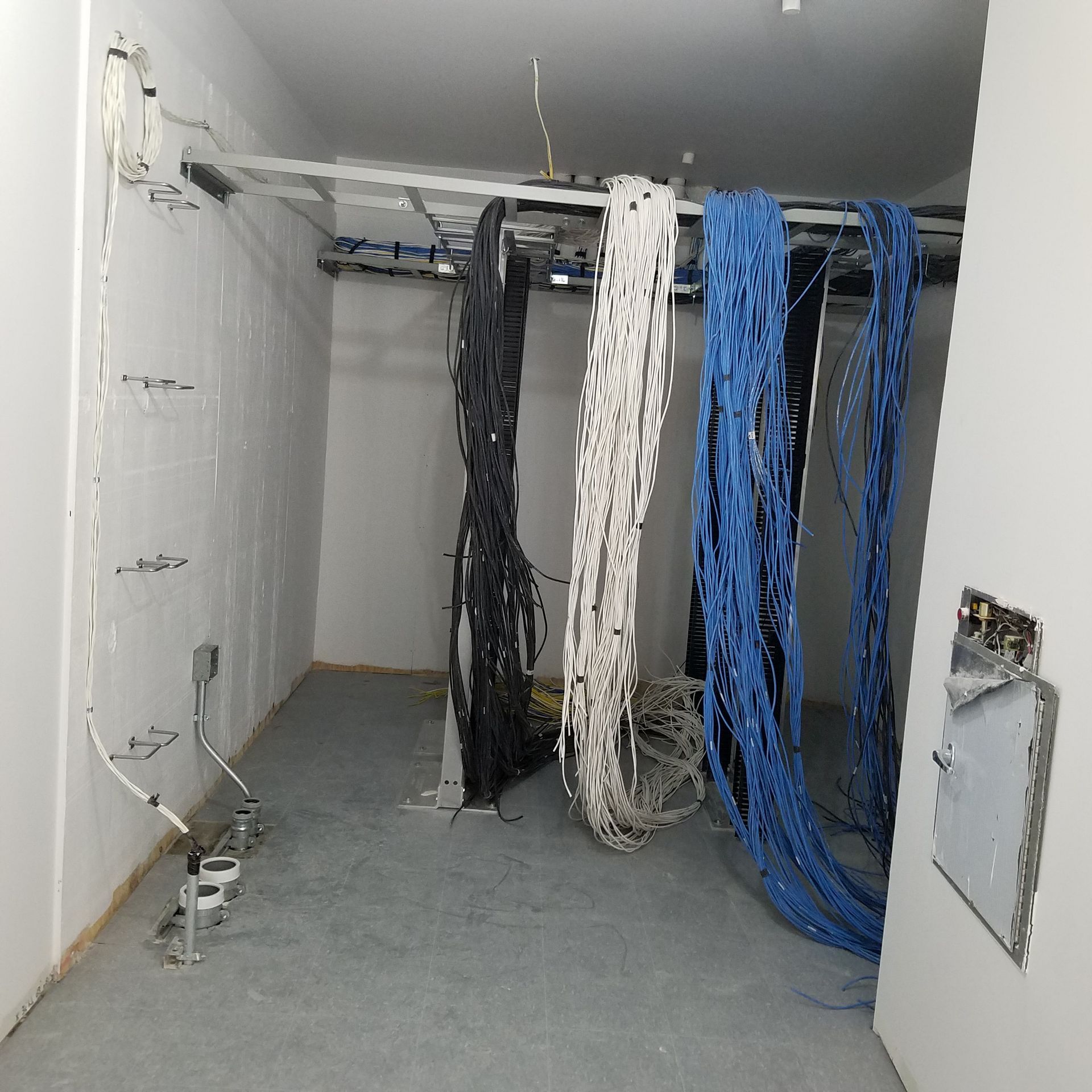 A room with a bunch of wires hanging from the ceiling