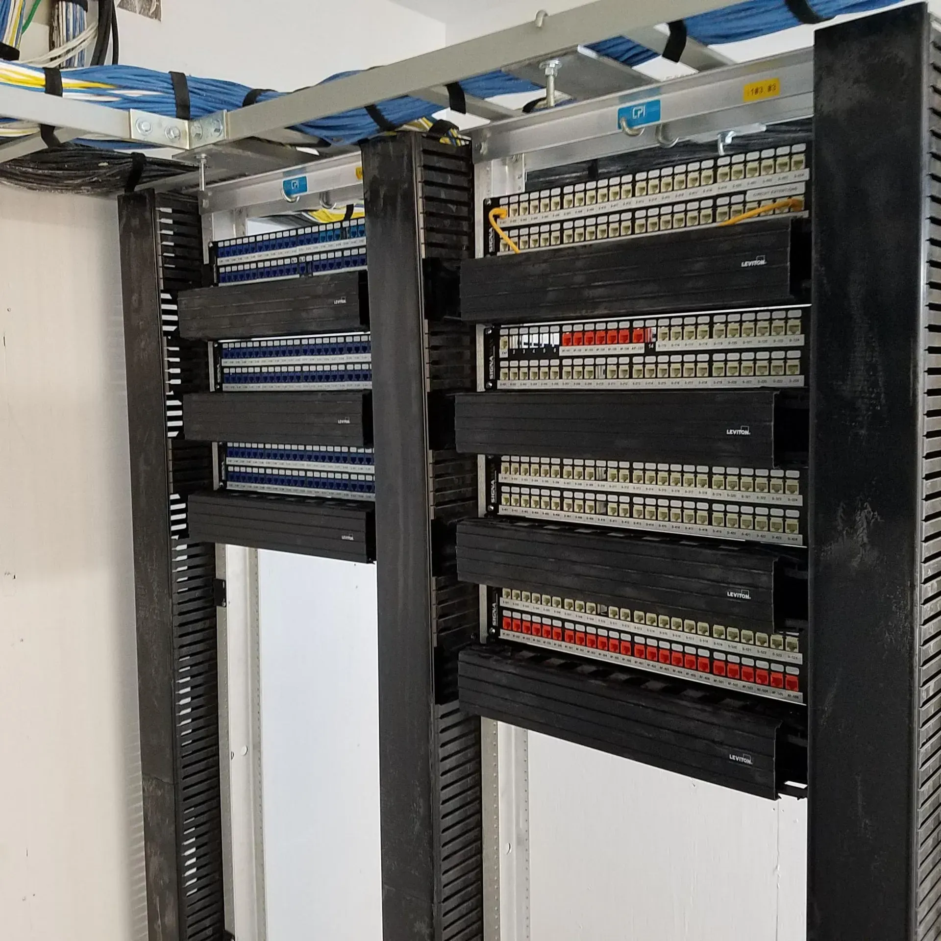 A server rack with a lot of wires coming out of it