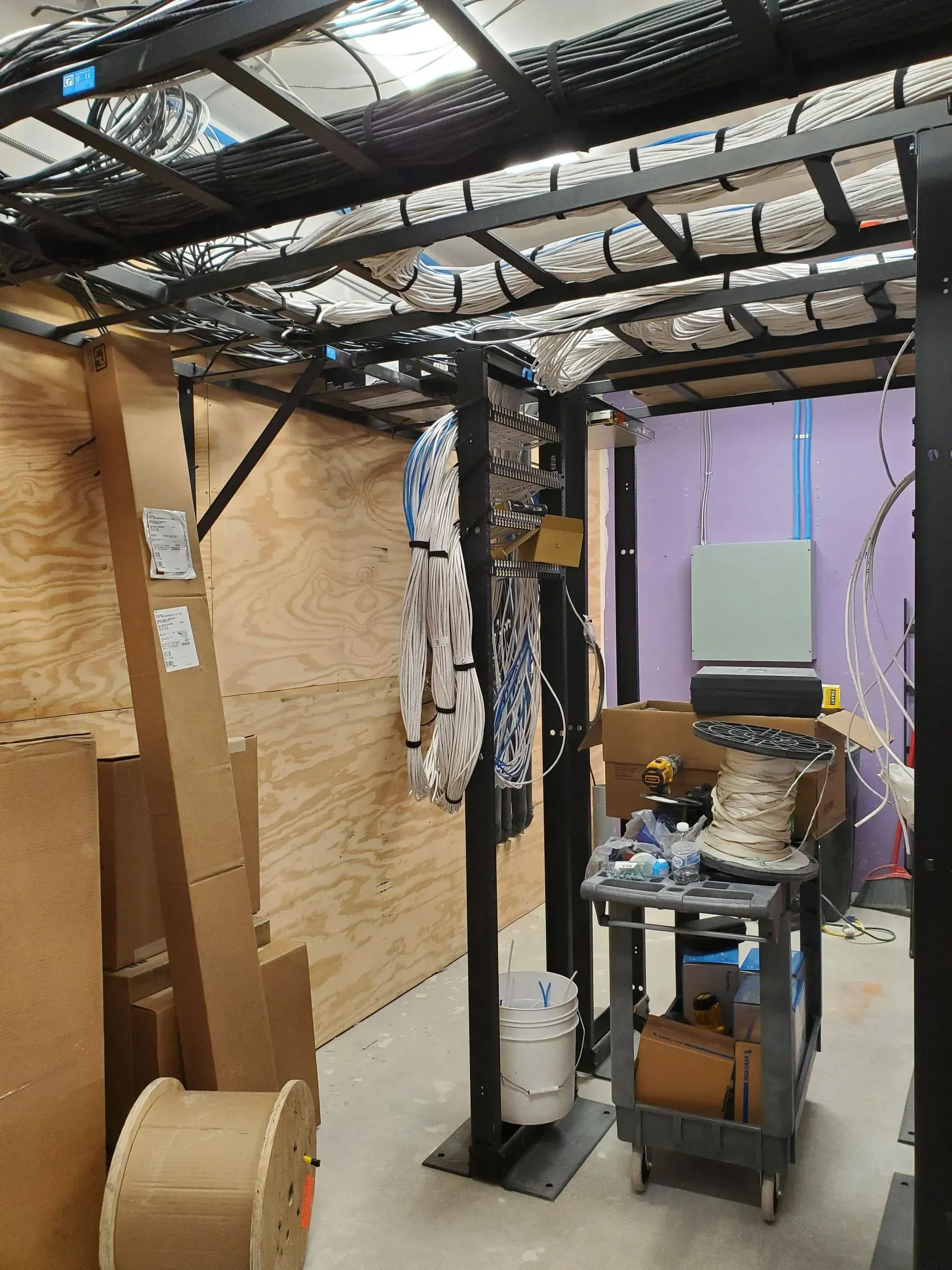 A room with a lot of wires hanging from the ceiling