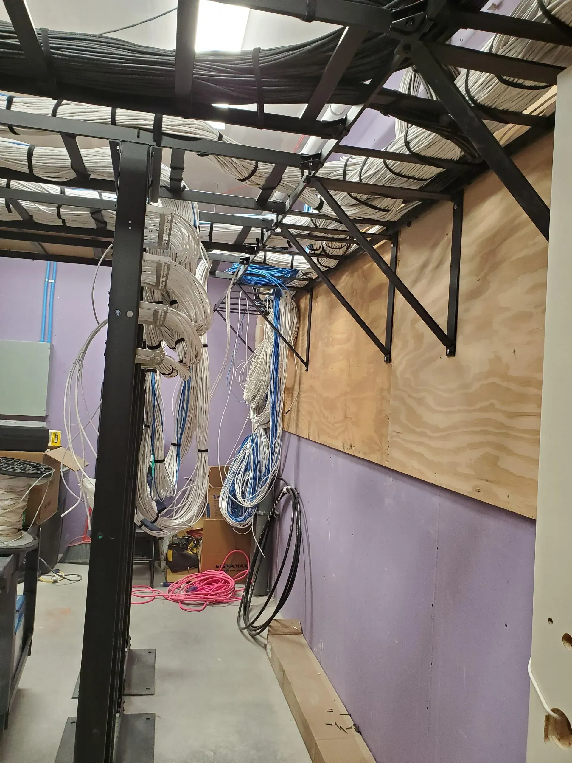 A room with a lot of wires hanging from the ceiling.