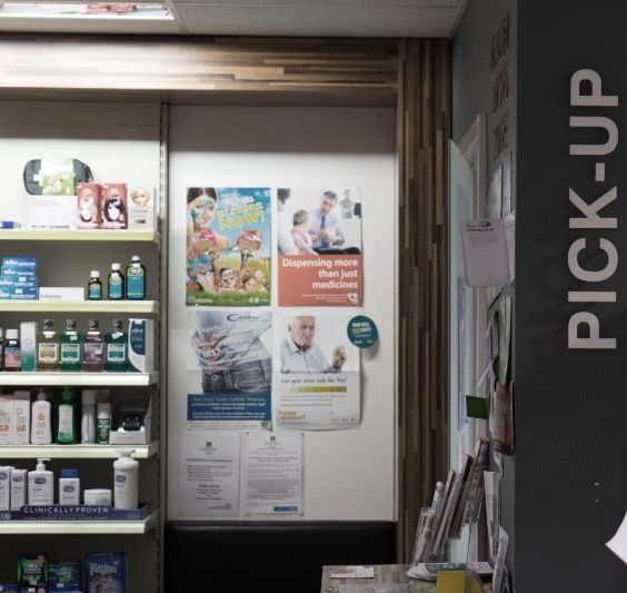 A pharmacy with a pick up sign on the wall