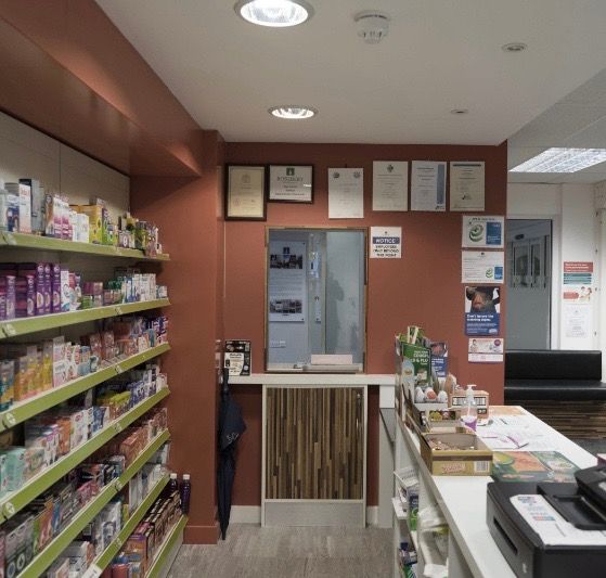 The inside of a pharmacy with a printer on the counter