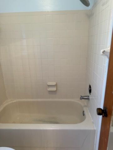 A bathroom with a bathtub and a toilet