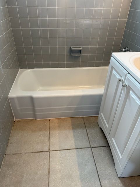 A bathroom with a bathtub and a sink