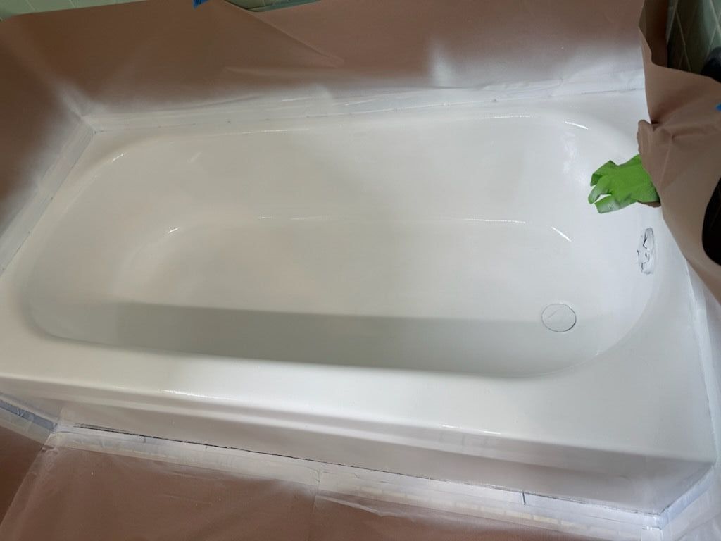 Bathtub in the bathroom with white tiles
