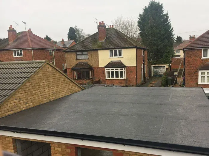 Rooftop view of suburban brick houses under an overcast sky