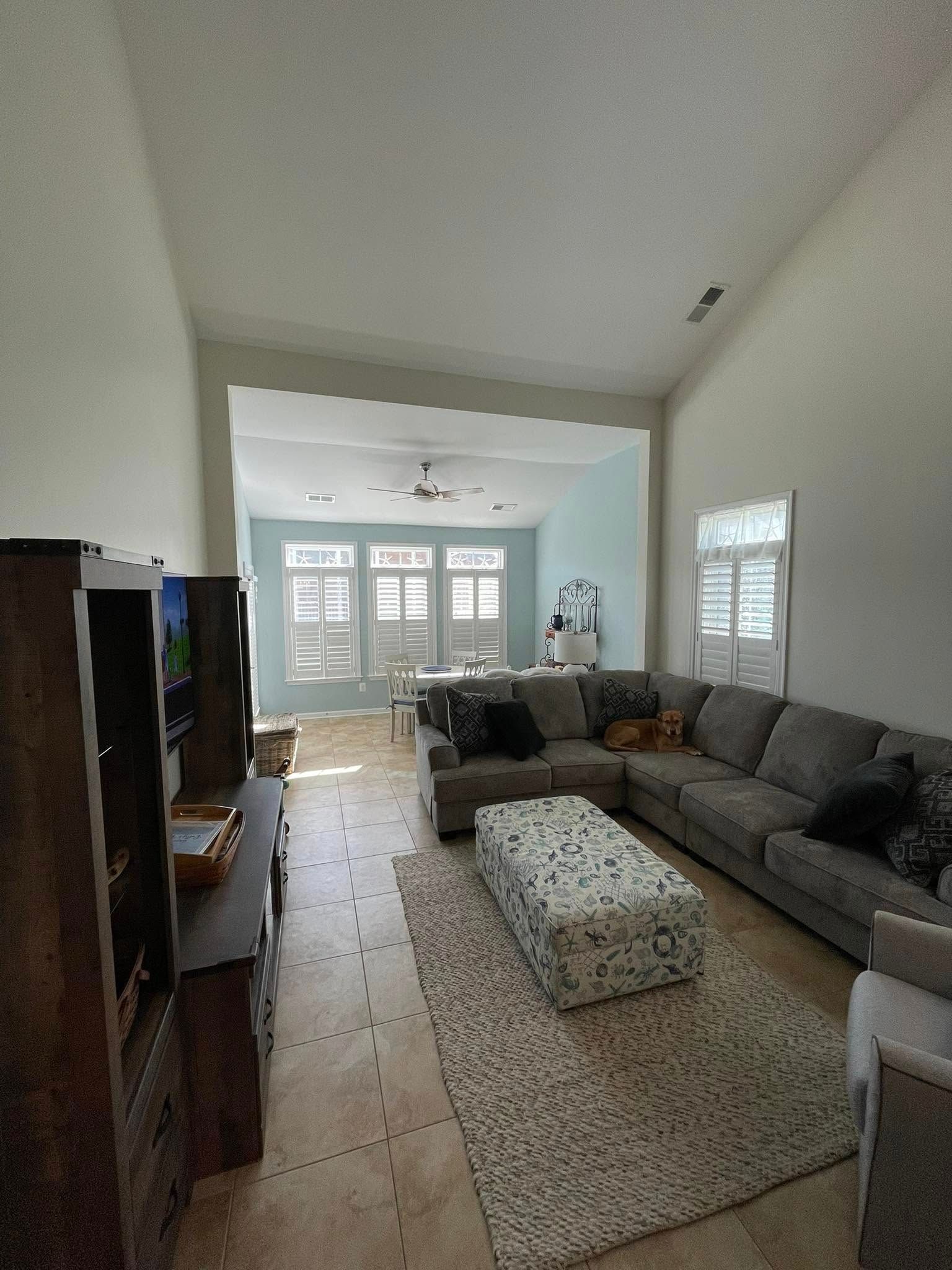 A living room with a large sectional couch and a coffee table.