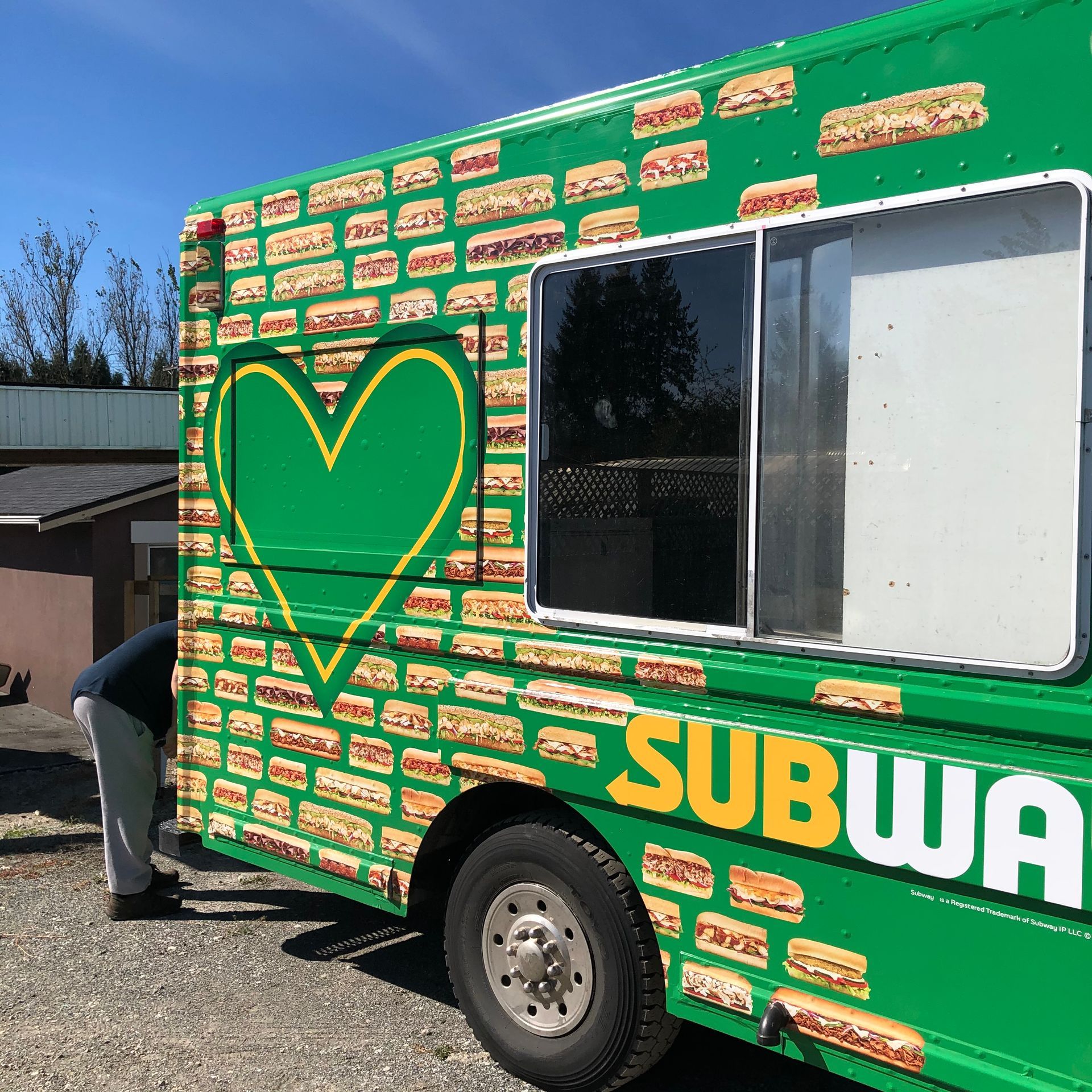 A green subway truck with a heart on the side