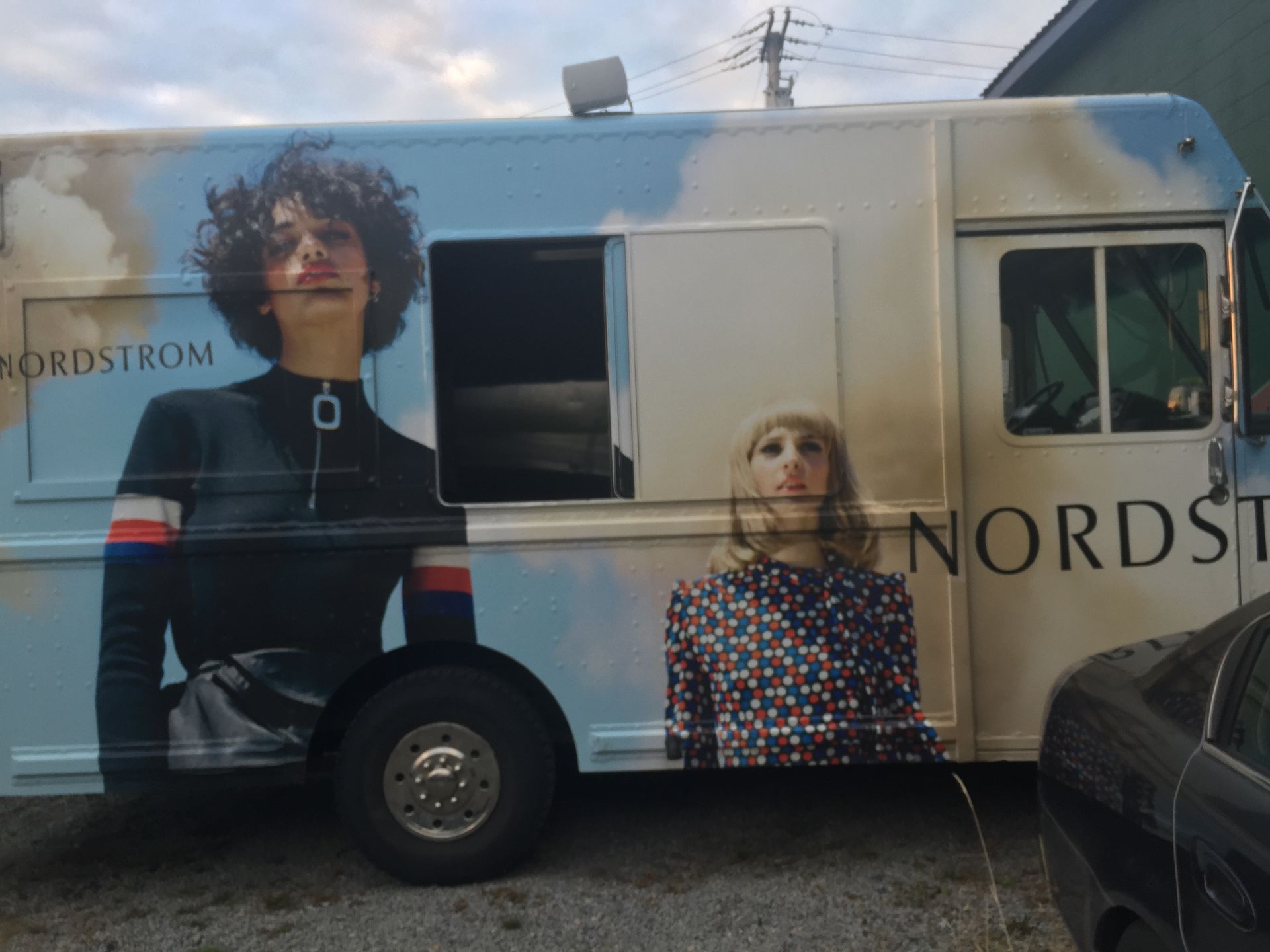 A nordstrom truck is parked in a parking lot