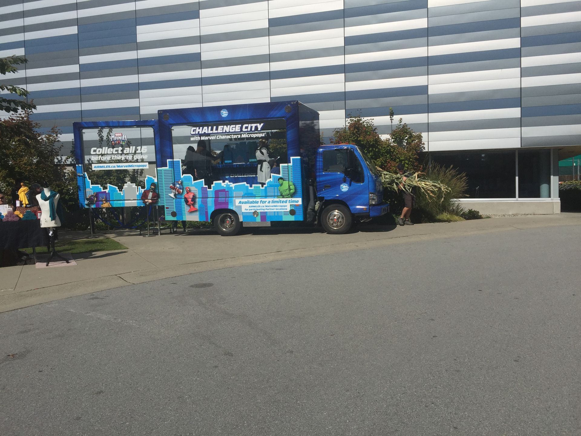 A challenge city truck is parked in front of a building