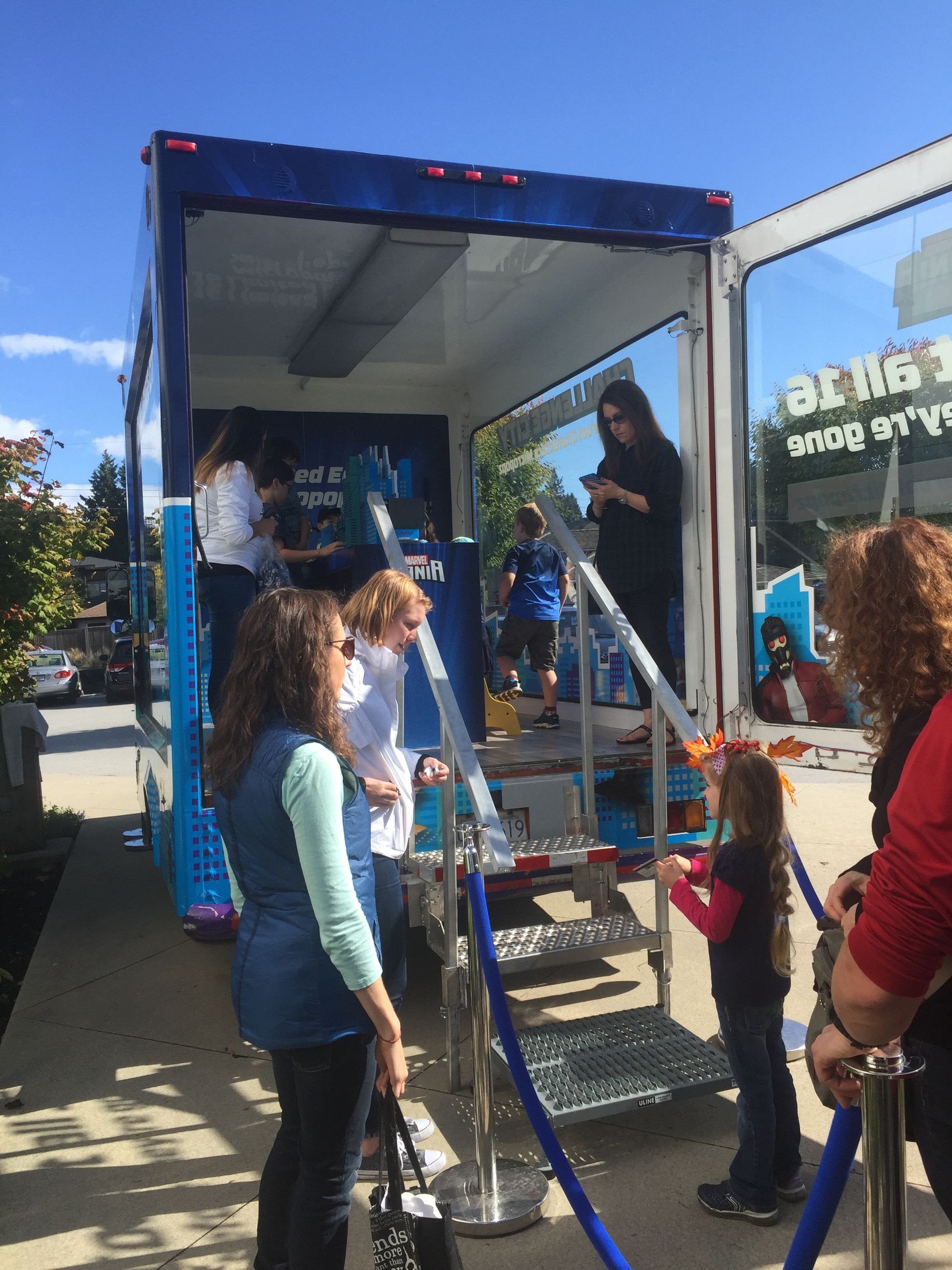 A group of people are standing in front of a food truck.