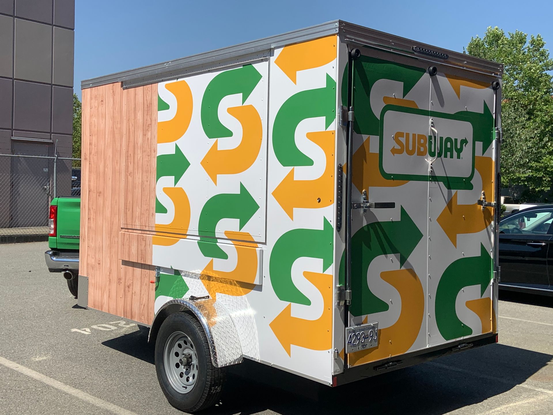 A subway trailer is parked in a parking lot
