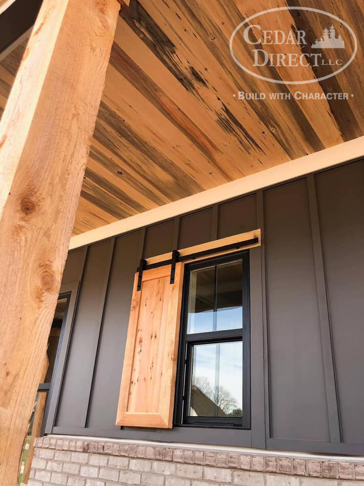 A sliding barn door is on the side of a house