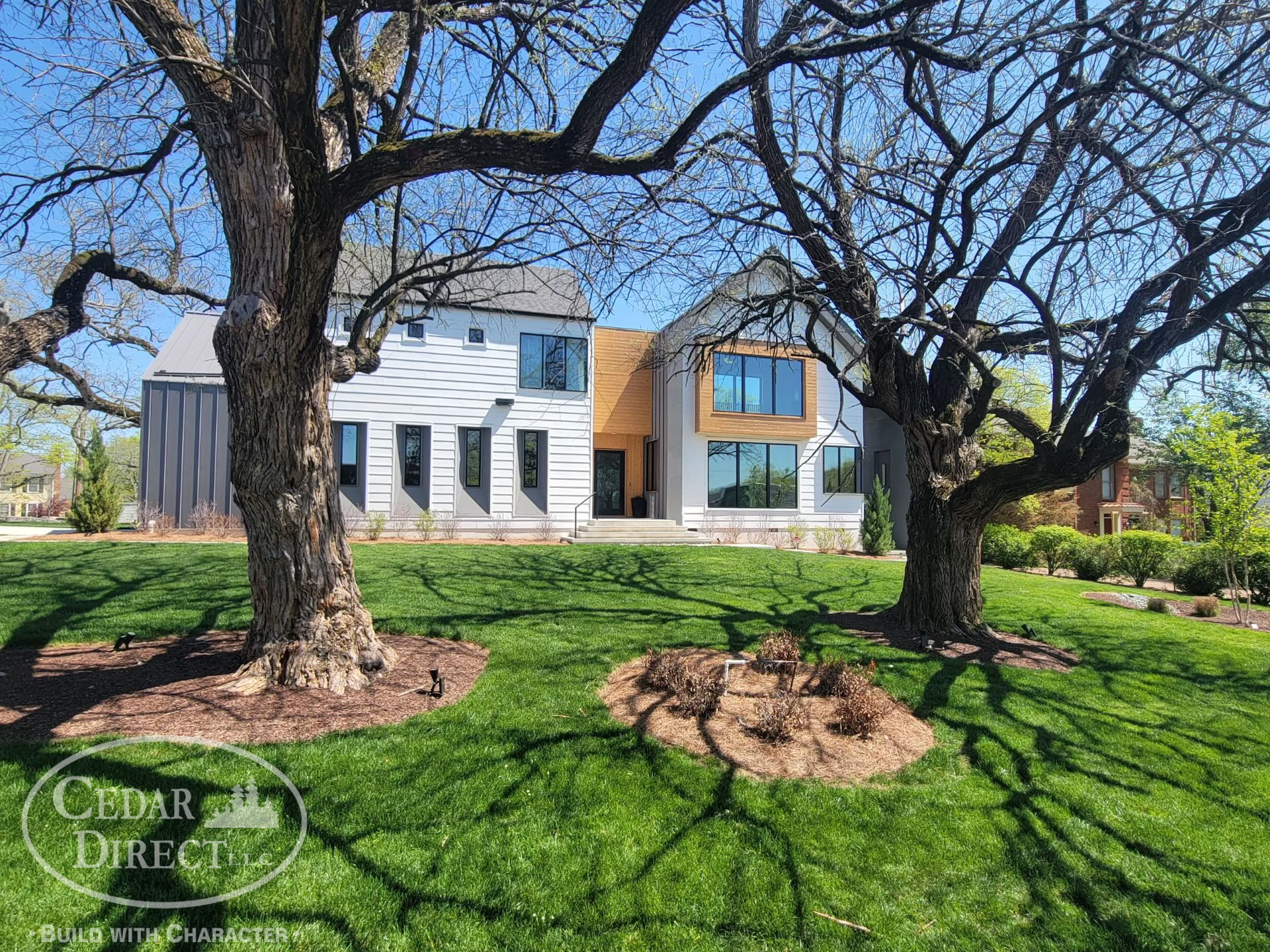 A large house with a lot of windows and trees in front of it.