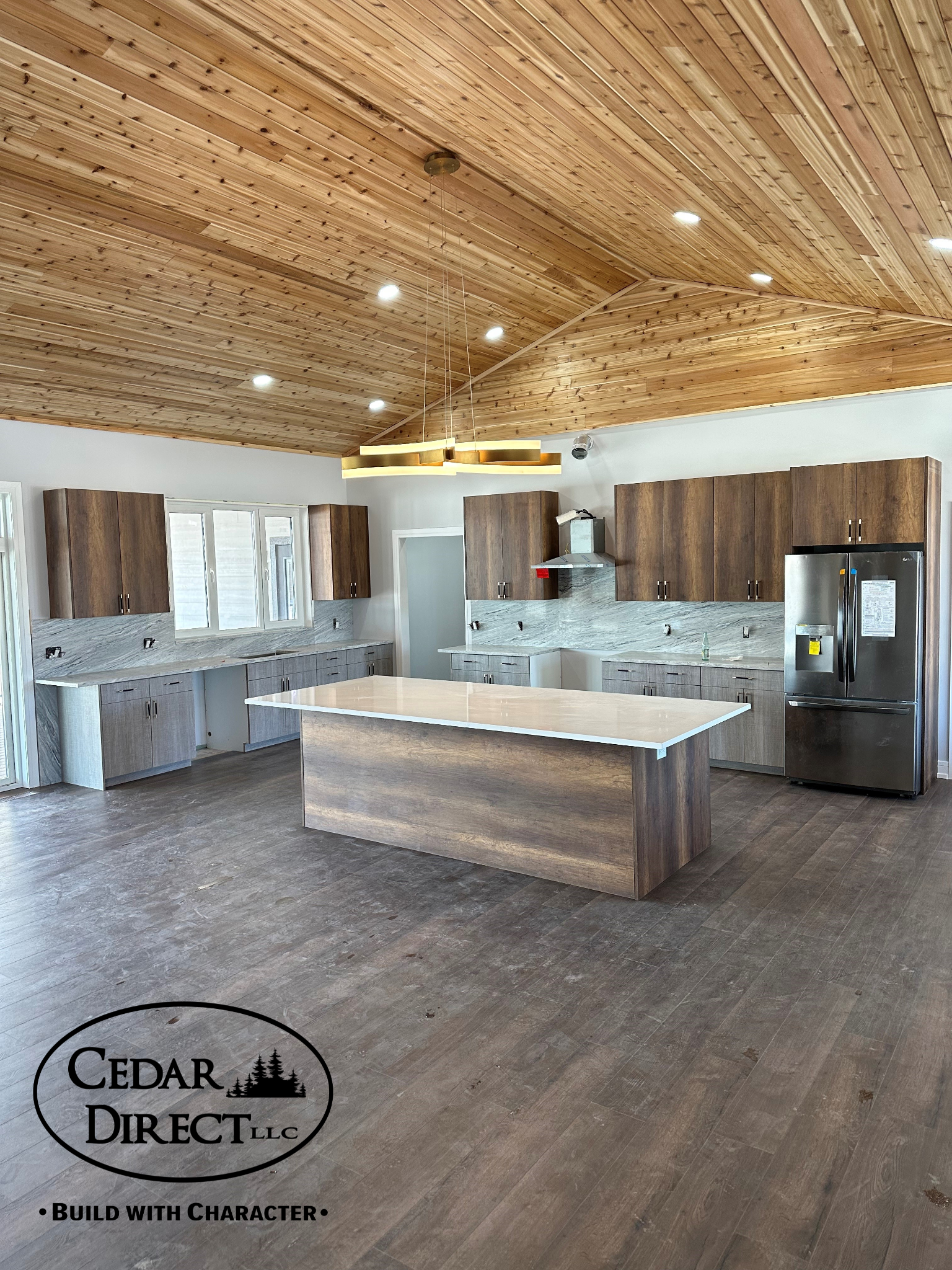 A kitchen with wooden cabinets and a large island in the middle.
