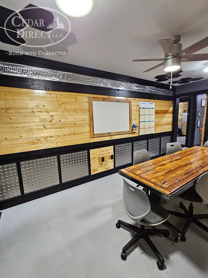A conference room with a wooden table and chairs