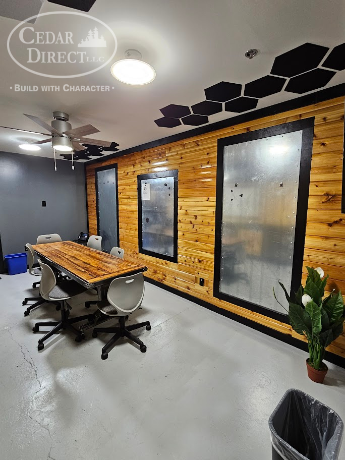 A conference room with a wooden table and chairs.