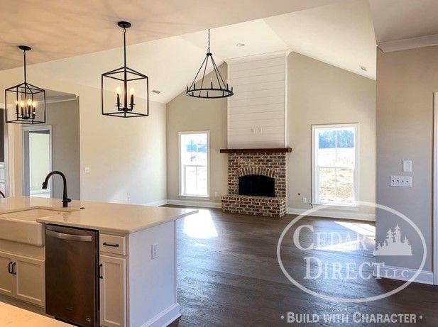 A kitchen with a fireplace and a sign that says build with character