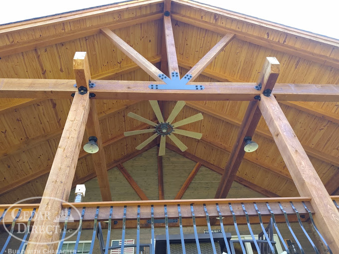 A ceiling fan is hanging from the roof of a building