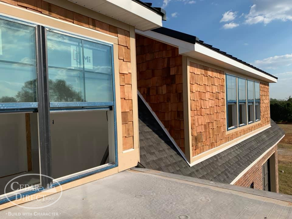 A house with a lot of windows and a roof