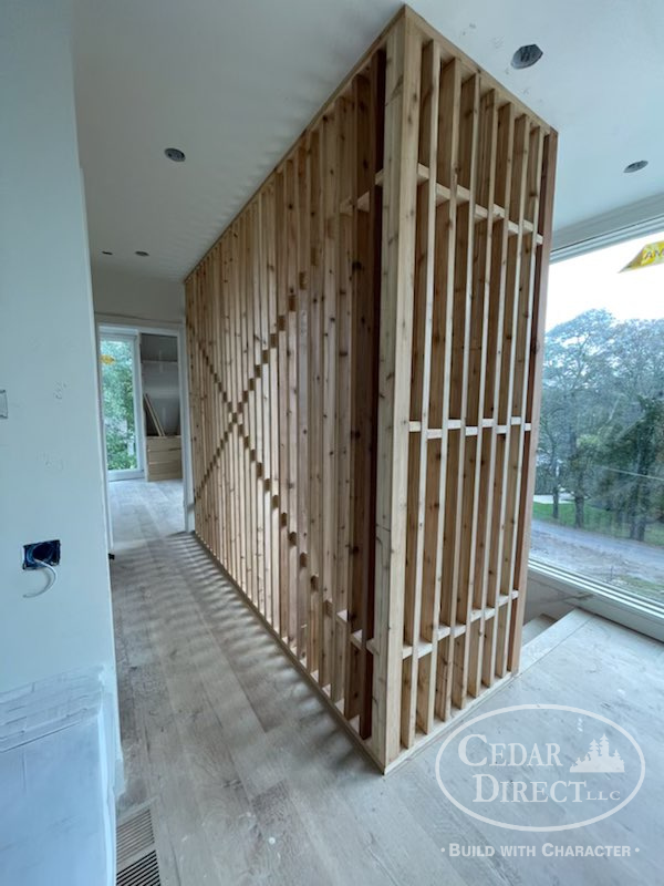 A wooden wall is being built in a house by cedar direct