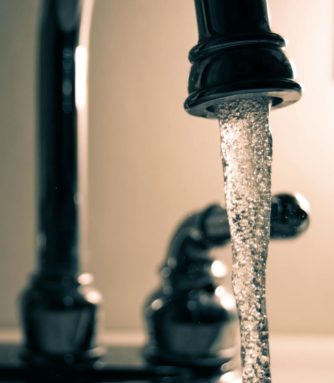 A close up of a faucet with water running out of it
