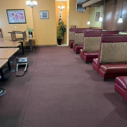 an empty diner with red booths and tables