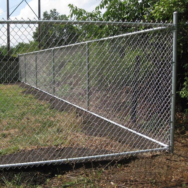 A chain link fence with a gate that is open