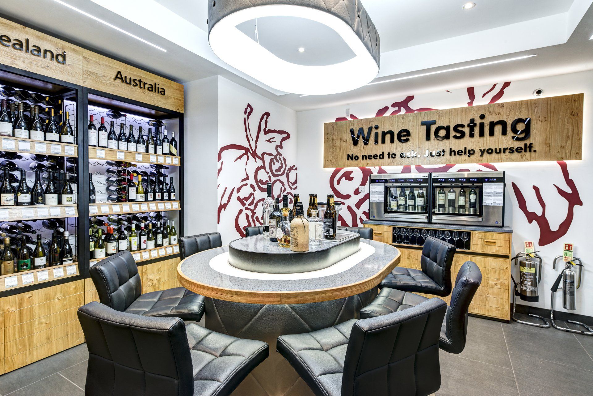 a tasting area for fine wines showing leather seating arranged around a tall pedestal