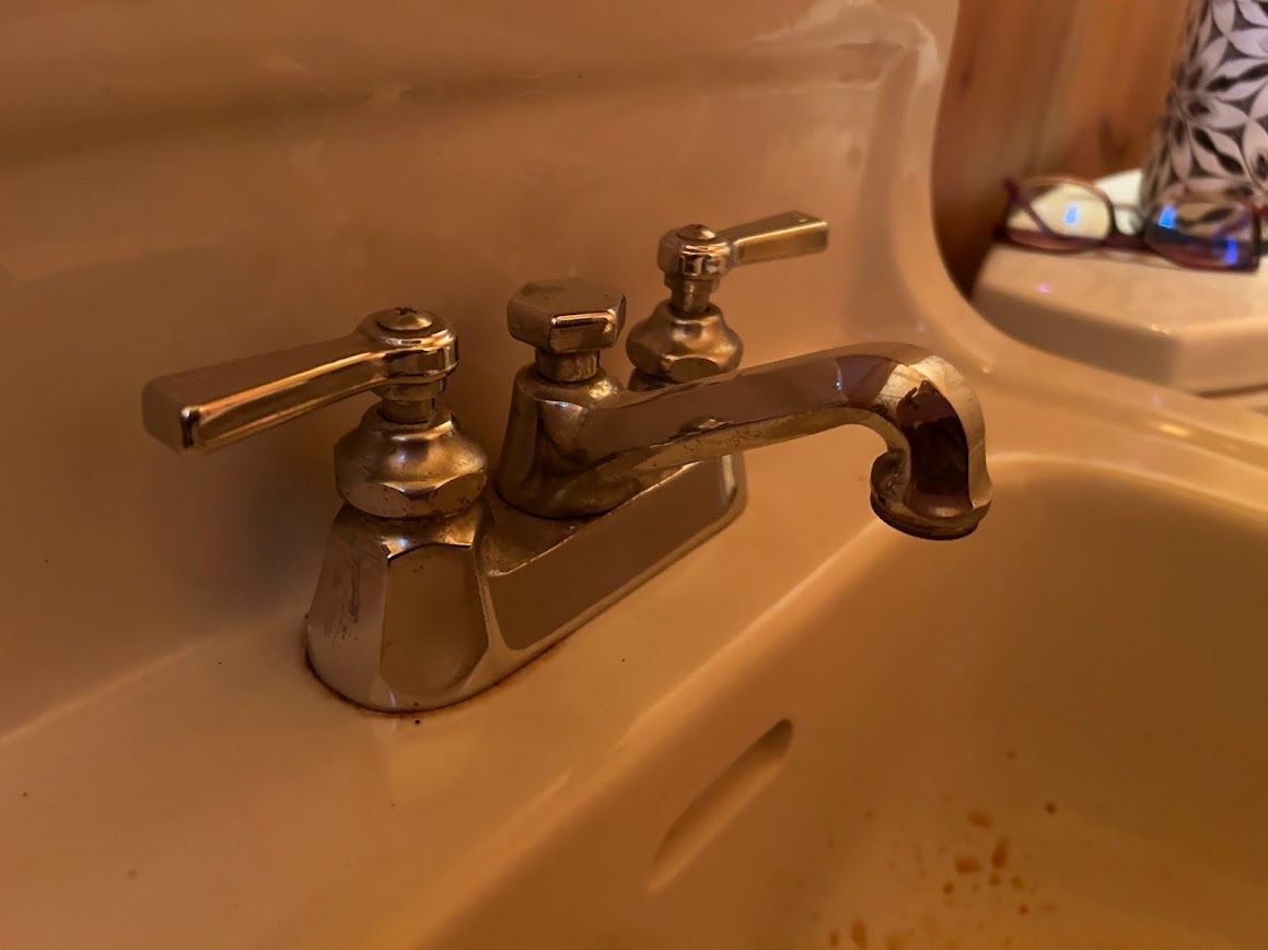 A close up of a faucet on a bathroom sink