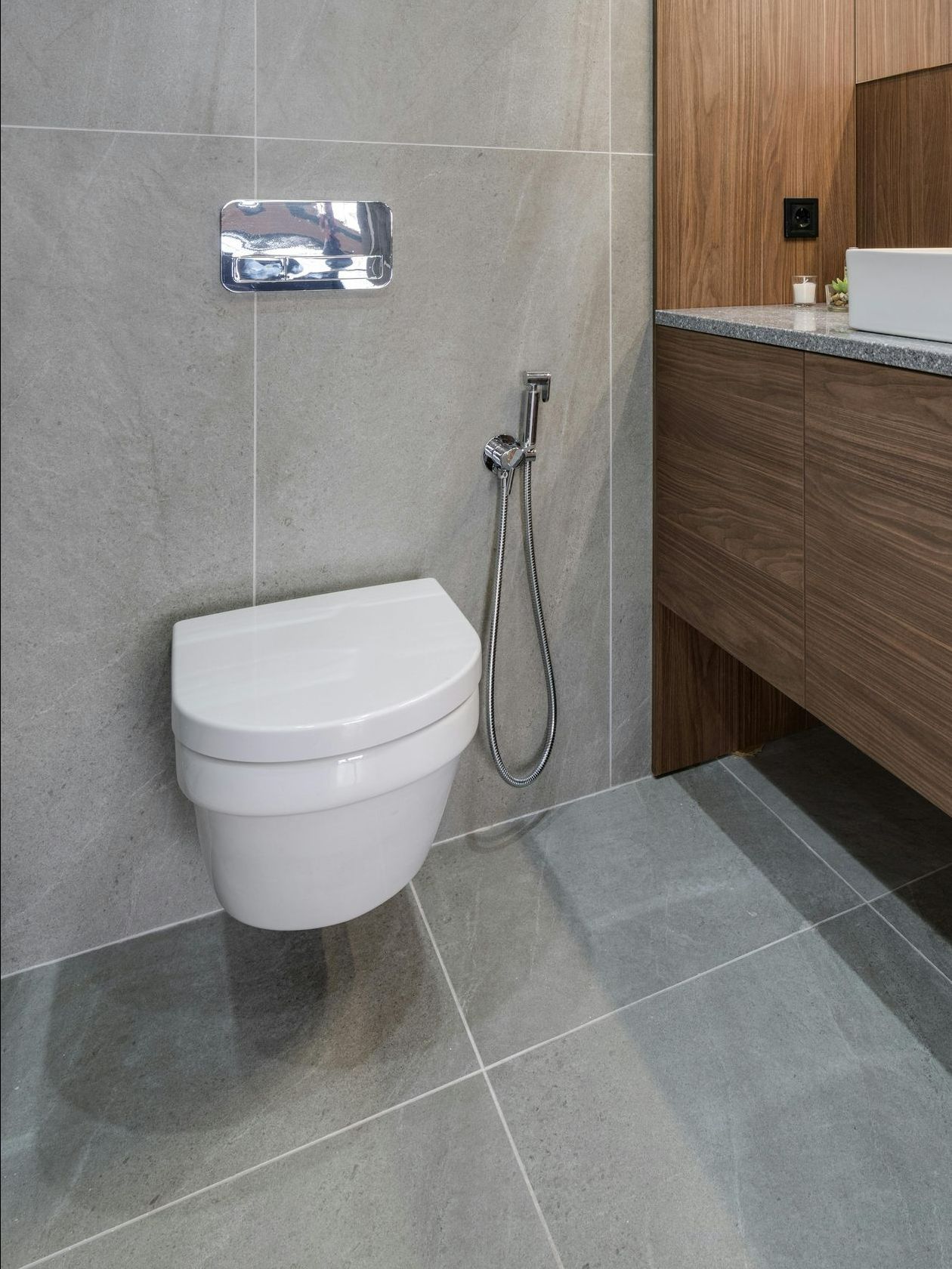 A white bathtub is sitting on the floor in a bathroom next to a toilet.