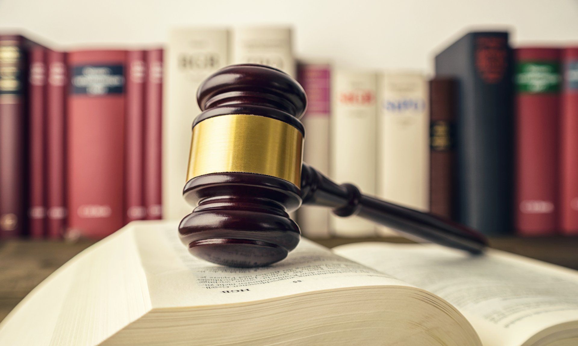 Powers of Attorney — Open Law Book with a Judge Gavel in De Pere, WI Powers of Attorney — Open Law Book with a Judge Gavel in De Pere, WI