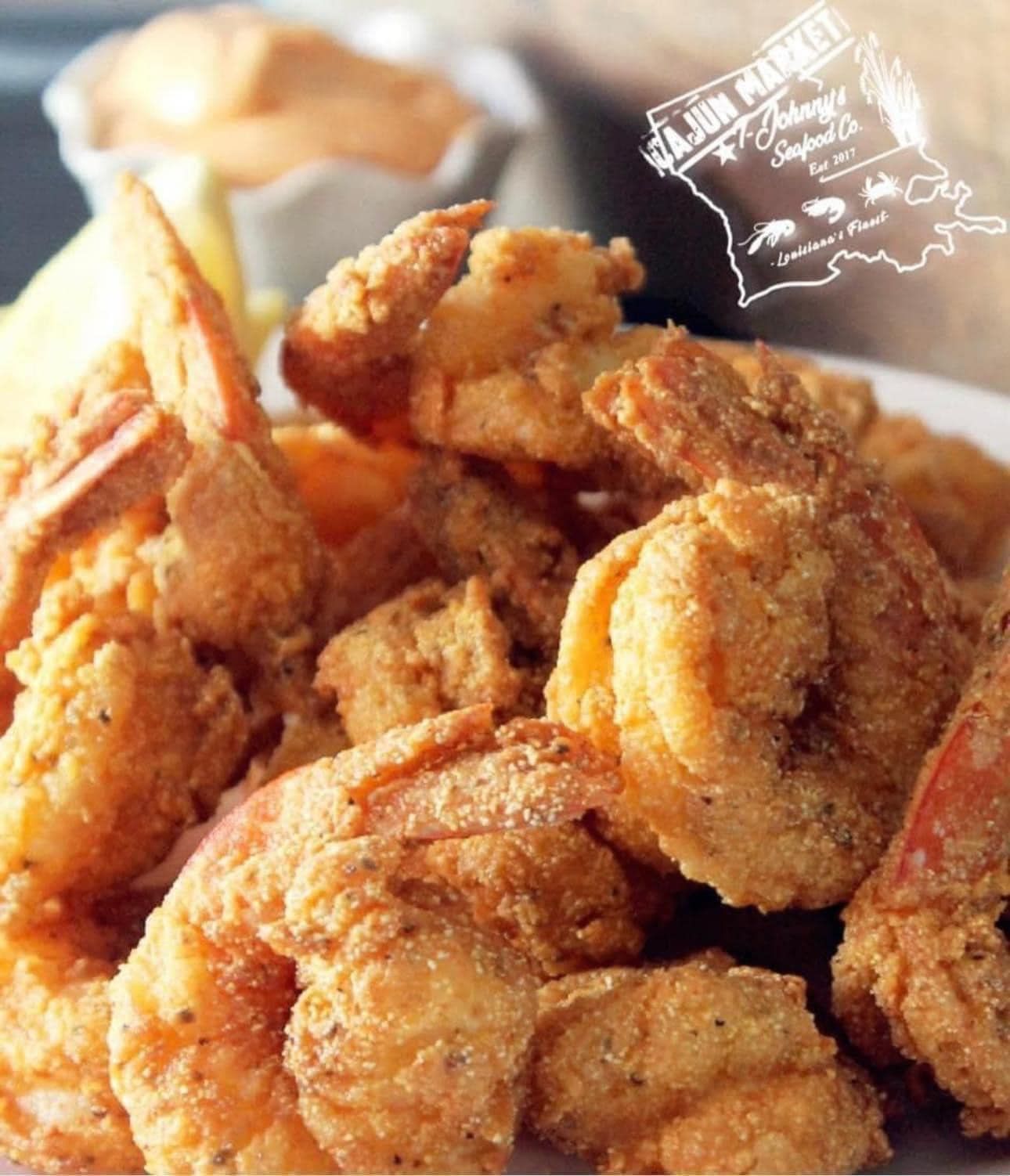 A plate of fried shrimp with a sign that says a june market