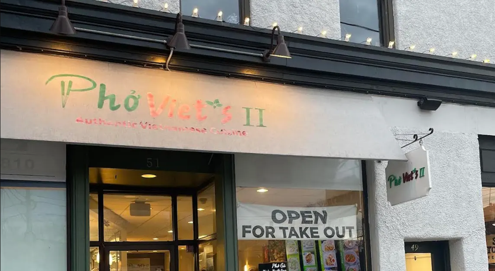 The front of Phở Viet's II restaurant with a sign that says open for take out.