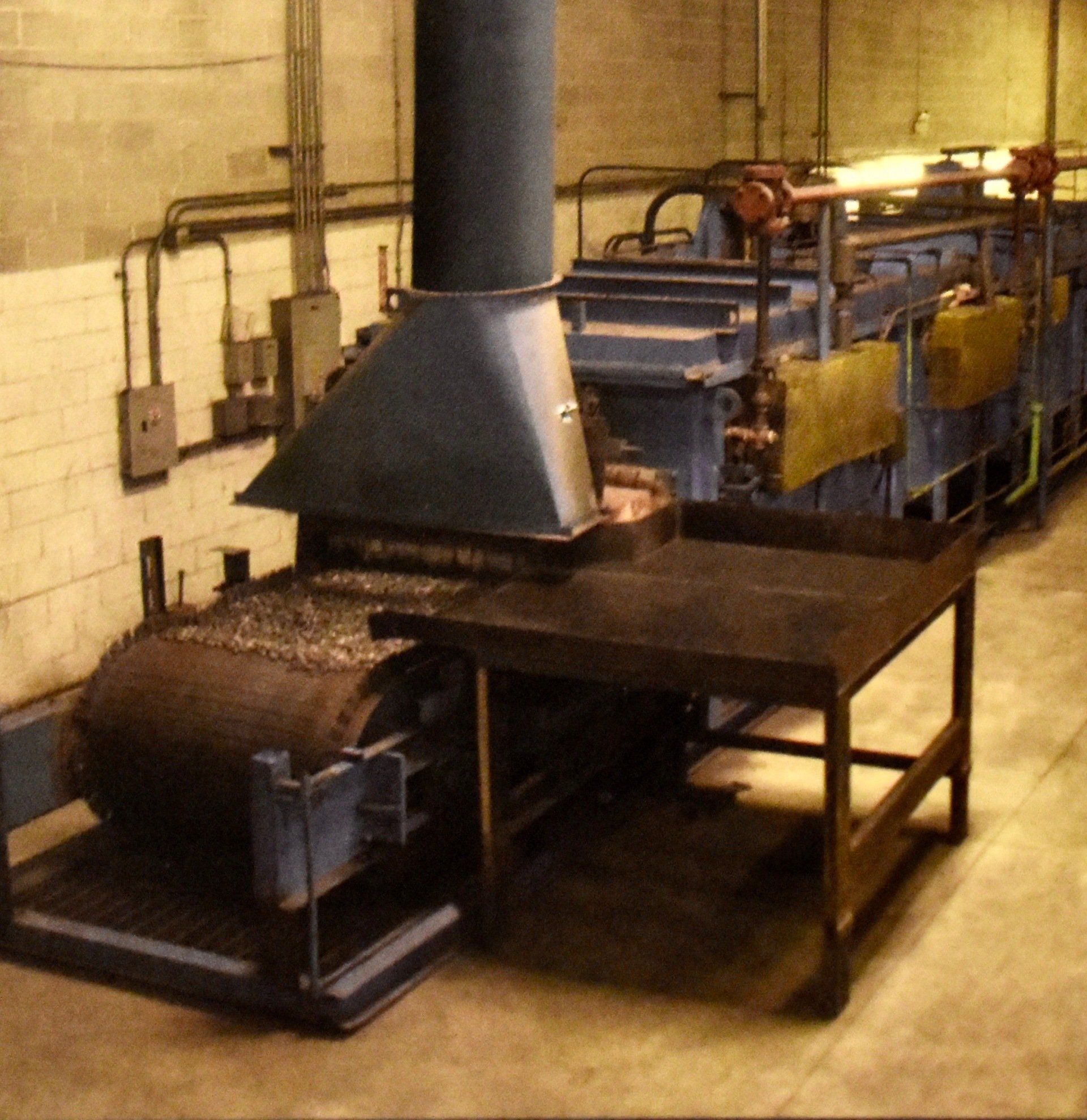 A room with a lot of machinery and a table