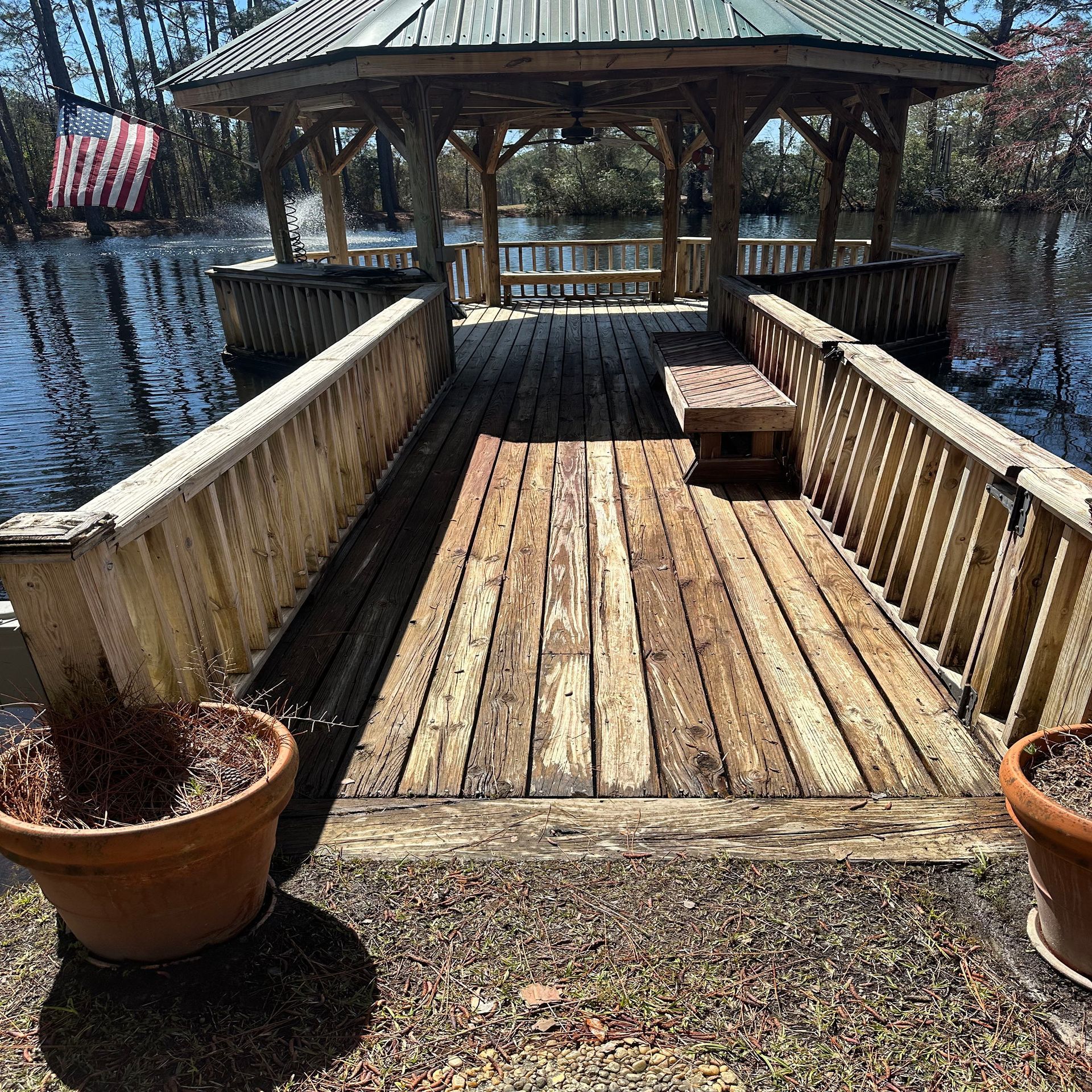 A wooden gazebo overlooking a body of water