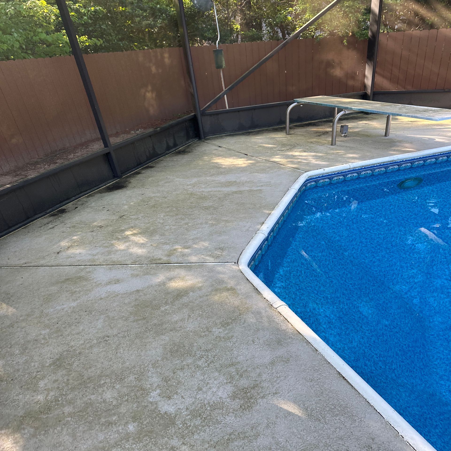 A swimming pool with a fence surrounding it