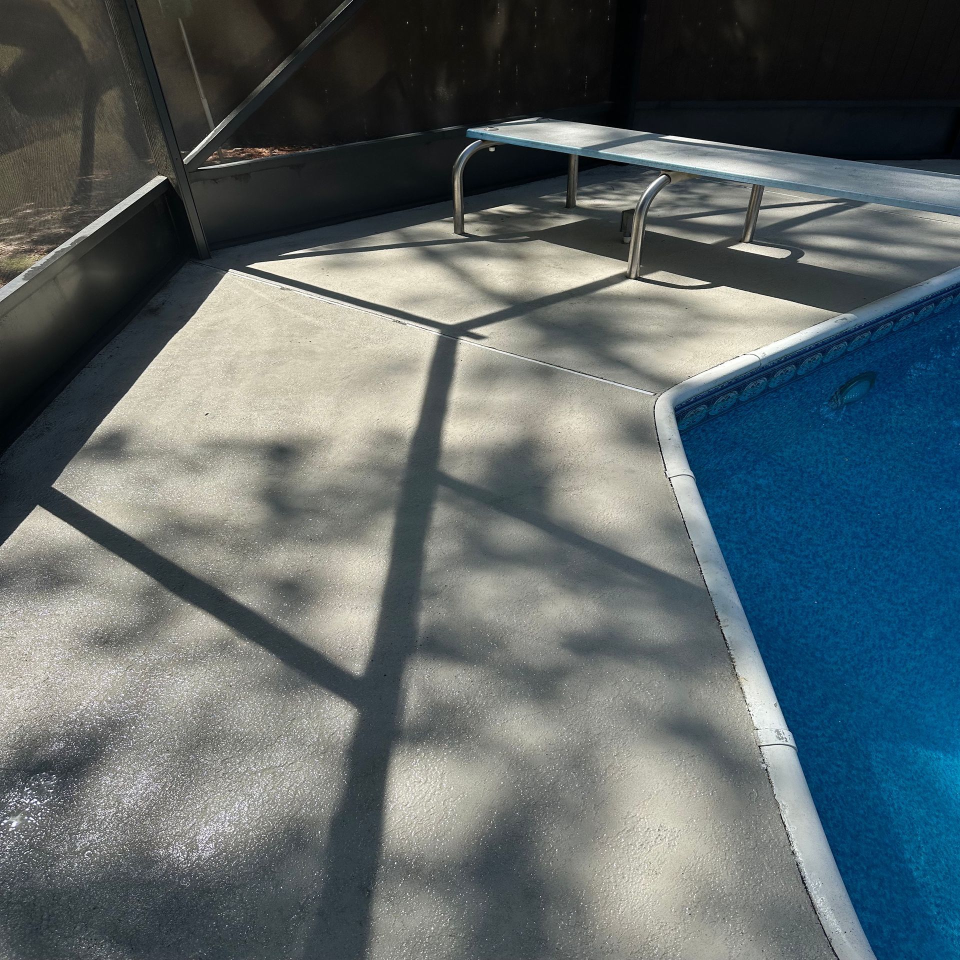 A swimming pool with a bench next to it