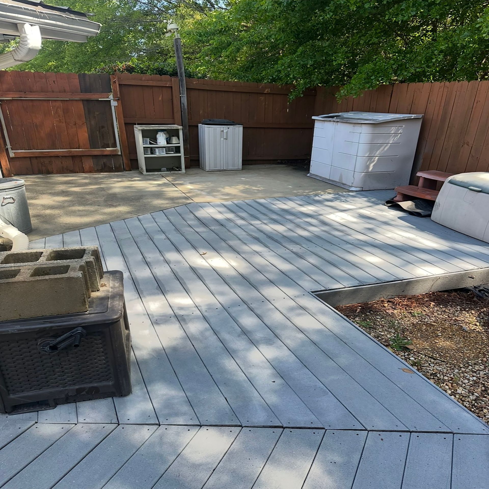 A timber deck supporting a pile of concrete blocks above it