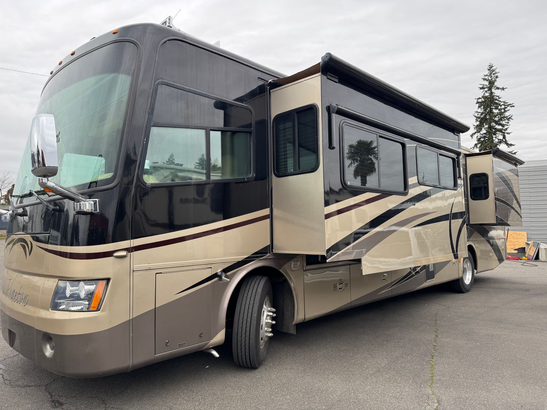 A large rv is parked in a parking lot.