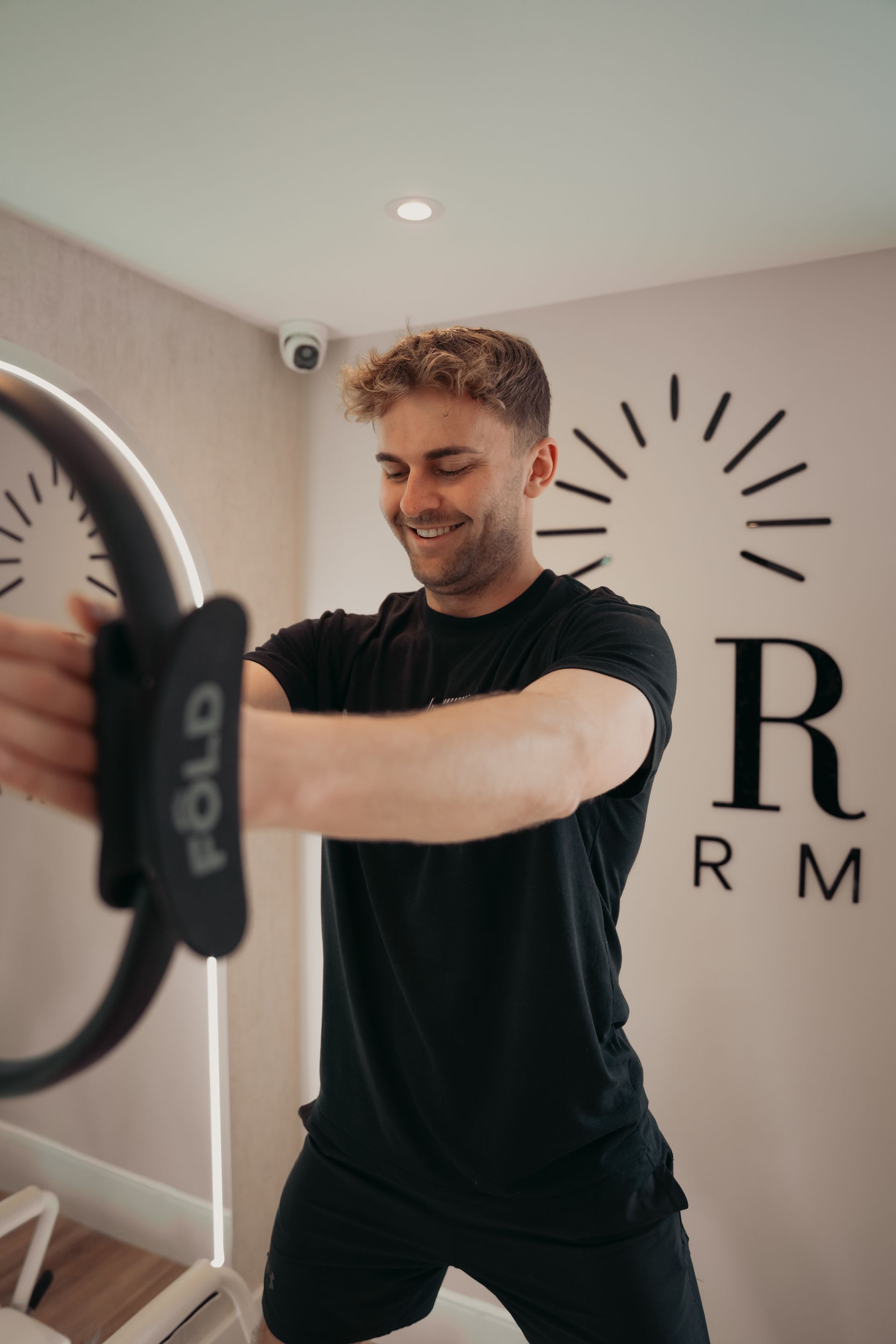 Leg and foot on Pilates machine, ankle resting on a beige padded block, toes pointed.