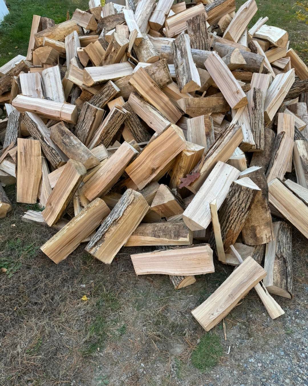 A pile of wood is sitting on the ground.